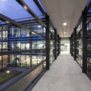 The concrete-floored skybridge provides a visual link between architecture, building, daylighting, metropolitan area, mixed use, reflection, black, gray