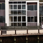 Exterio view of the Martha Cove apartments that apartment, architecture, building, condominium, facade, house, real estate, reflection, residential area, water, waterway, window, black, white