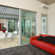 A view of the living and dining areas, apartment, architecture, ceiling, door, floor, house, interior design, living room, property, real estate, window, gray