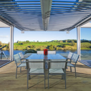 A view of the dining area, wooden deck canopy, estate, interior design, leisure, outdoor structure, property, real estate, roof, shade, swimming pool, vacation, window, gray