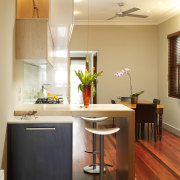 A view of the kitchen, wooden flooring, cabinetry, cabinetry, countertop, cuisine classique, floor, hardwood, home, interior design, kitchen, room, table, wood flooring, orange