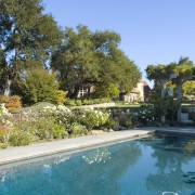 View of the pool. - View of the backyard, estate, garden, home, house, landscape, landscaping, leisure, property, real estate, resort, resort town, swimming pool, tree, villa, teal