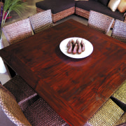 A view of this Samarang furniture that features flooring, furniture, hardwood, table, wood, wood stain, red