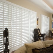 A view of the interior living areas featuring ceiling, curtain, home, interior design, living room, room, wall, window, window blind, window covering, window treatment, wood, gray