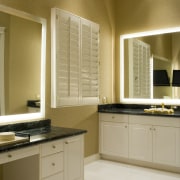 A view of the interior living areas featuring bathroom, bathroom accessory, bathroom cabinet, cabinetry, countertop, cuisine classique, floor, flooring, home, interior design, kitchen, room, sink, window, brown