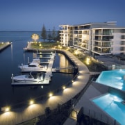 An exterior view of the New Stocland Allisse condominium, dock, hotel, luxury yacht, marina, mixed use, passenger ship, property, real estate, resort, yacht, blue