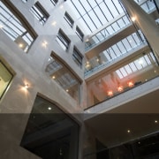 The solidity of the heards building ois expressed apartment, architecture, building, ceiling, corporate headquarters, daylighting, glass, headquarters, interior design, lobby, structure, window, black