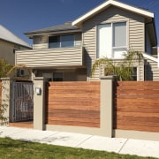 An exterior view of this house featuring Jame building, elevation, facade, fence, gate, home, home fencing, house, neighbourhood, property, real estate, residential area, siding, suburb, orange