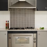 Authentic detailing on the architecture is matched by cabinetry, countertop, home appliance, interior design, kitchen, kitchen appliance, kitchen stove, oven, gray, black