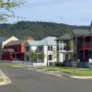 Tullimbar Village houses offer classic-look frontages, uncluttered by city, estate, home, house, mixed use, neighbourhood, property, real estate, residential area, road, suburb, town, tree, gray