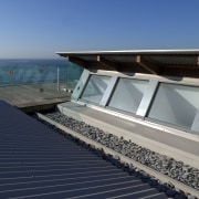 Accessible from a concealed staircase in the living architecture, daylighting, house, roof, sea, sky, water, gray, blue