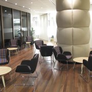 A predominantly brown and taupe colour palette is ceiling, chair, conference hall, floor, flooring, furniture, hardwood, interior design, lobby, table, waiting room, wood, wood flooring, brown