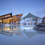 The main pool and beach resturant at Radisson architecture, estate, evening, home, hotel, leisure, mixed use, real estate, reflection, resort, resort town, sky, swimming pool, water, teal, blue
