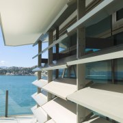 Fully operable sun louvres contribute to a contemporay apartment, architecture, balcony, condominium, estate, house, penthouse apartment, property, real estate, resort, swimming pool, teal, black