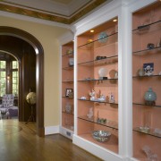 A view of a hallway, wooden flooring, display bookcase, cabinetry, display case, furniture, interior design, lobby, shelf, shelving, red, brown