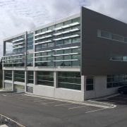 This sustainable office building in Auckland, the head architecture, building, commercial building, condominium, corporate headquarters, facade, headquarters, metropolitan area, mixed use, real estate, residential area, black, gray, white