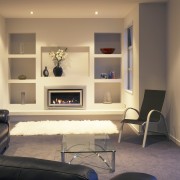 A view of a fireplace from Escea. - floor, flooring, furniture, home, interior design, living room, room, shelving, wall, orange