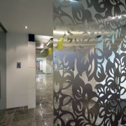 A glass screen with a delicate leaf pattern ceiling, glass, interior design, lobby, mural, wall, gray, black