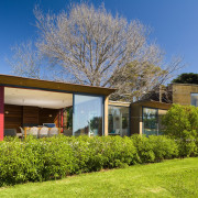 An exterior view of the home, windows and architecture, cottage, estate, facade, farmhouse, grass, home, house, landscape, lawn, plant, property, real estate, residential area, roof, siding, sky, suburb, tree, villa, yard