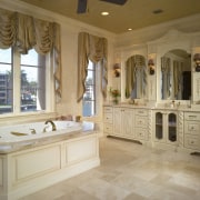 View of the master bathroom featuring a handcarved bathroom, cabinetry, ceiling, countertop, estate, floor, flooring, home, interior design, room, tile, wall, window, wood flooring, brown, orange