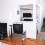 view of kitchen and living area before renovations home appliance, living room, property, room, white