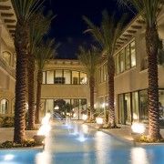 View of a home built by Domanico Custom architecture, arecales, building, condominium, estate, evening, hacienda, home, hotel, landscape lighting, lighting, mansion, night, palm tree, property, real estate, reflection, resort, sky, swimming pool, tree, villa, water, brown