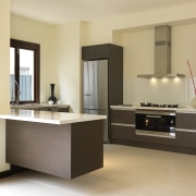 Rather than specifying standard 60cm cooking appliances, the cabinetry, countertop, floor, furniture, interior design, kitchen, product design, room, sink, orange, brown