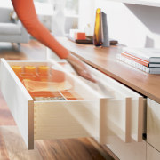 A view of a drawer system by Blum desk, drawer, floor, furniture, orange, product design, shelf, shelving, table, wood, white, orange