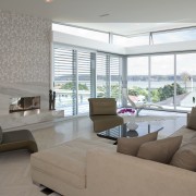 Wilson has augmented the white-on-white theme, evident throughout floor, house, interior design, living room, penthouse apartment, property, real estate, window, gray