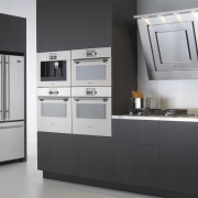 A view of some kitchen appliances by Maytag. countertop, home appliance, kitchen, kitchen appliance, kitchen stove, major appliance, product, product design, refrigerator, gray, black