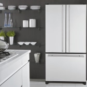 A view of some kitchen appliances by Maytag. countertop, home appliance, interior design, kitchen, kitchen appliance, kitchen stove, major appliance, product, product design, refrigerator, white, black