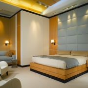 view of master bedroom featuring padded wall feature, bed frame, bedroom, ceiling, hotel, interior design, room, suite, wall, brown, orange, gray