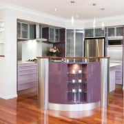 A view of a kitchen designed by KBDI. cabinetry, floor, flooring, hardwood, interior design, kitchen, property, real estate, room, wood flooring, white, red