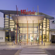 View of Westfield Manukau City Shopping Centre, with architecture, building, commercial building, corporate headquarters, facade, metropolitan area, mixed use, shopping mall, gray, blue