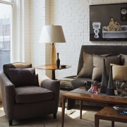 View of a living area in this apartment chair, coffee table, couch, furniture, home, interior design, lamp, lighting accessory, living room, loveseat, product design, room, table, black, gray