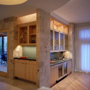 view of kitchen featuring island, tiled floor, wall cabinetry, ceiling, countertop, home, interior design, kitchen, real estate, room, wall, brown, gray
