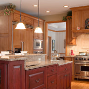 Finage cabinetry kitchen, with countertops, kitchen appliances. cabinetry, countertop, cuisine classique, floor, flooring, furniture, hardwood, home, interior design, kitchen, room, wood, wood flooring, brown