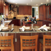 view of kitchen by Dream Kitchens, featuring cabinetry, countertop, interior design, kitchen, restaurant, room, red