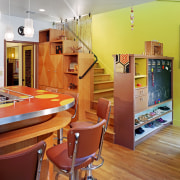 view of kitchen showing stairway leading to next architecture, ceiling, floor, flooring, home, interior design, kitchen, living room, loft, orange, real estate, room, table, wall, red, gray