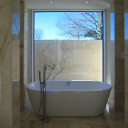 Marble walls and flooring inside master ensuite - architecture, bathroom, bathtub, daylighting, floor, glass, home, house, interior design, plumbing fixture, room, tile, window, black, gray