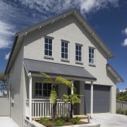 Exterior view of contemporary home created by developer building, cottage, elevation, estate, facade, home, house, property, real estate, residential area, roof, siding, window, gray