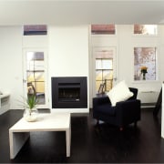 View of a lounge area, with dark flooring, furniture, interior design, living room, room, white, black, gray