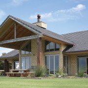 Exterior shot of front of house featuring clay cottage, elevation, estate, facade, farmhouse, home, house, outdoor structure, porch, property, real estate, roof, siding, teal