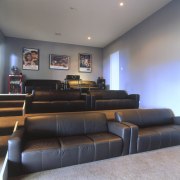 Comprehensively sound insulated media room inside Jennian home couch, furniture, interior design, living room, room, waiting room, gray, black