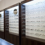 Image of Eyewear shop featuring cladding, cabinetry, tiled display case, furniture, glass, interior design, inventory, gray, black