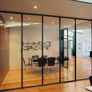 Steel-and-glass sliding doors allow the two meeting rooms architecture, ceiling, door, floor, flooring, furniture, glass, interior design, wall, window, brown, orange