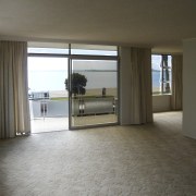 Image of the living room prior to renovations. apartment, floor, flooring, home, house, interior design, property, real estate, room, window, wood flooring, brown, gray