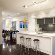 The kitchen has a symmetrical design, with a countertop, interior design, kitchen, real estate, room, white