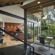Floor-to-ceiling windows provide city views, and a sense architecture, daylighting, glass, house, interior design, real estate, window, gray, brown
