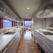 The kitchen is designed in a galley style ceiling, countertop, floor, interior design, kitchen, room, gray